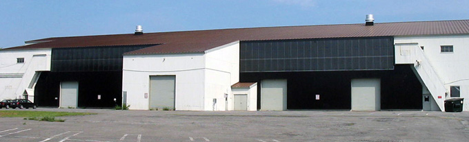 Two stage wall mounted solar heater, with the lower half unglazed and the upper half covered with glazing